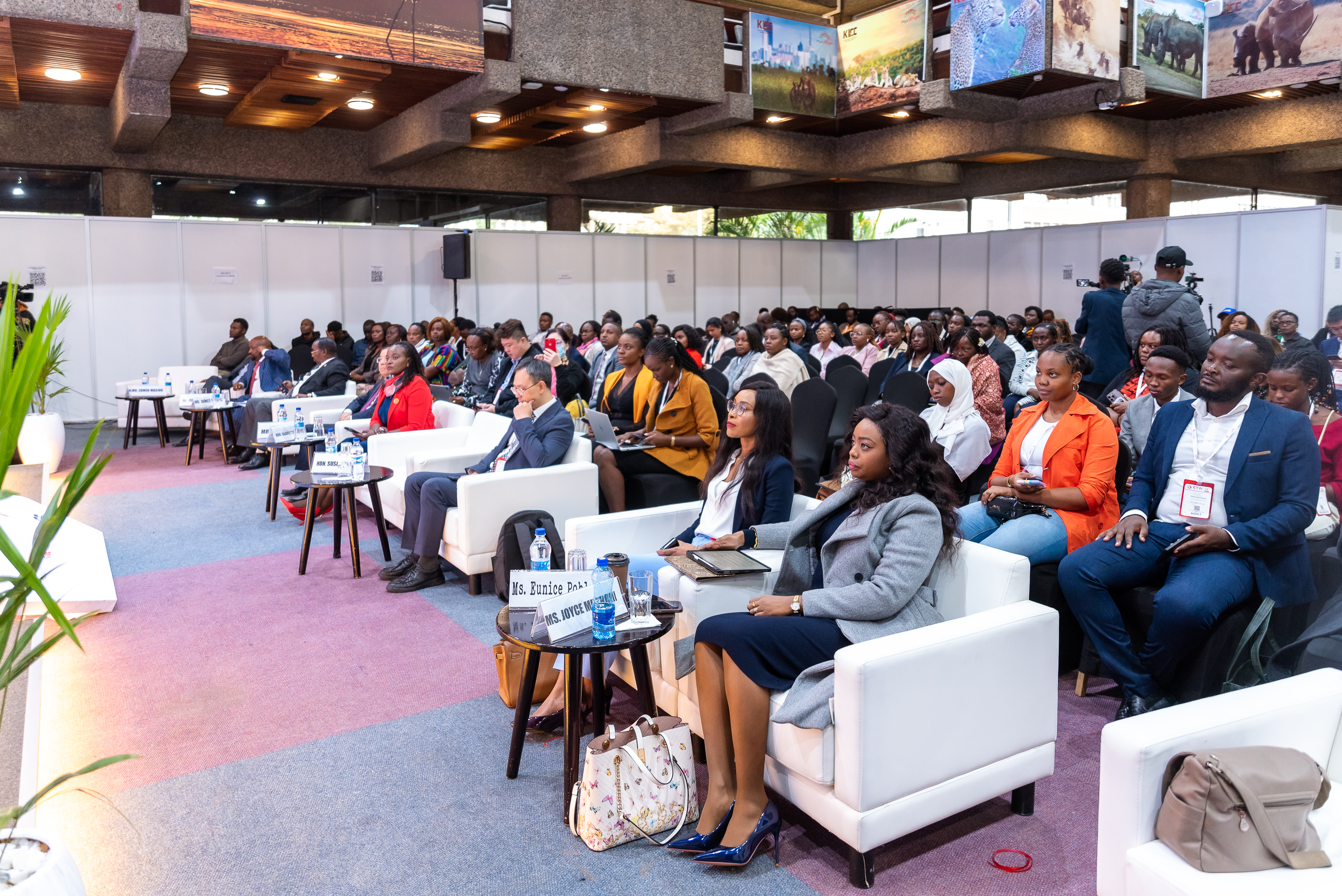 A full hall of attendees seated in front of the stage