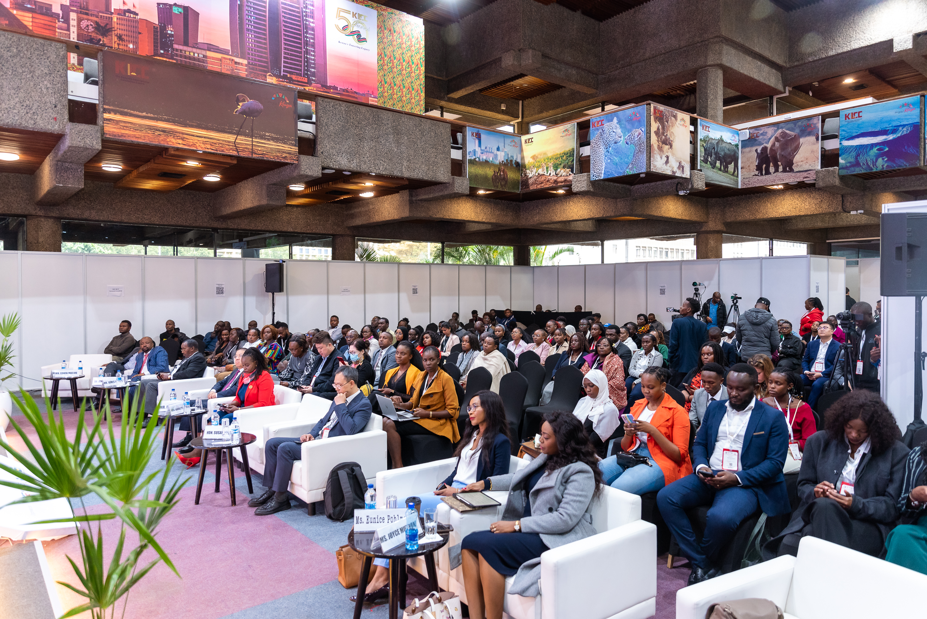 A wide view of the hall filled with attendees