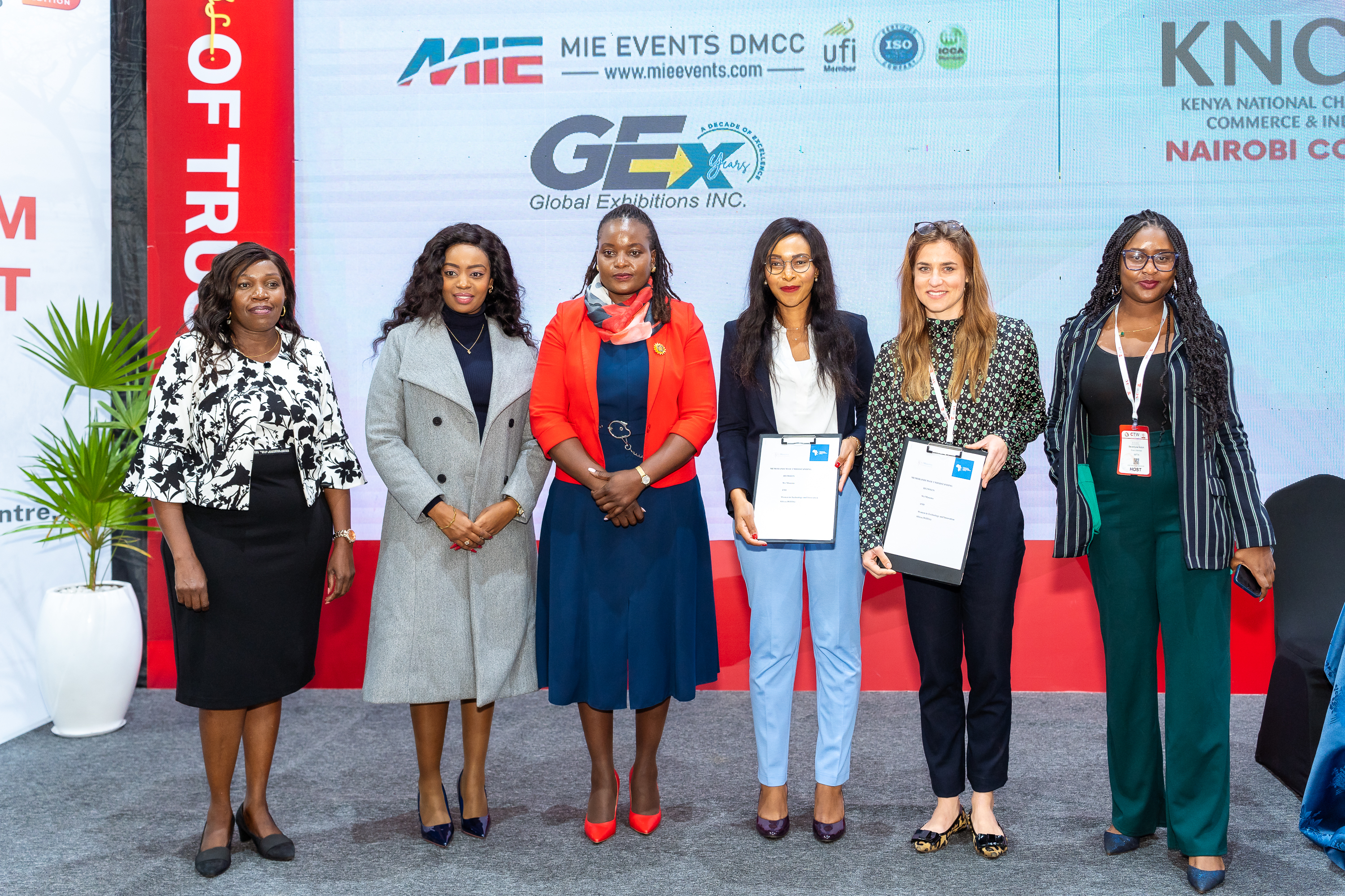Women standing on stage holding certificates
