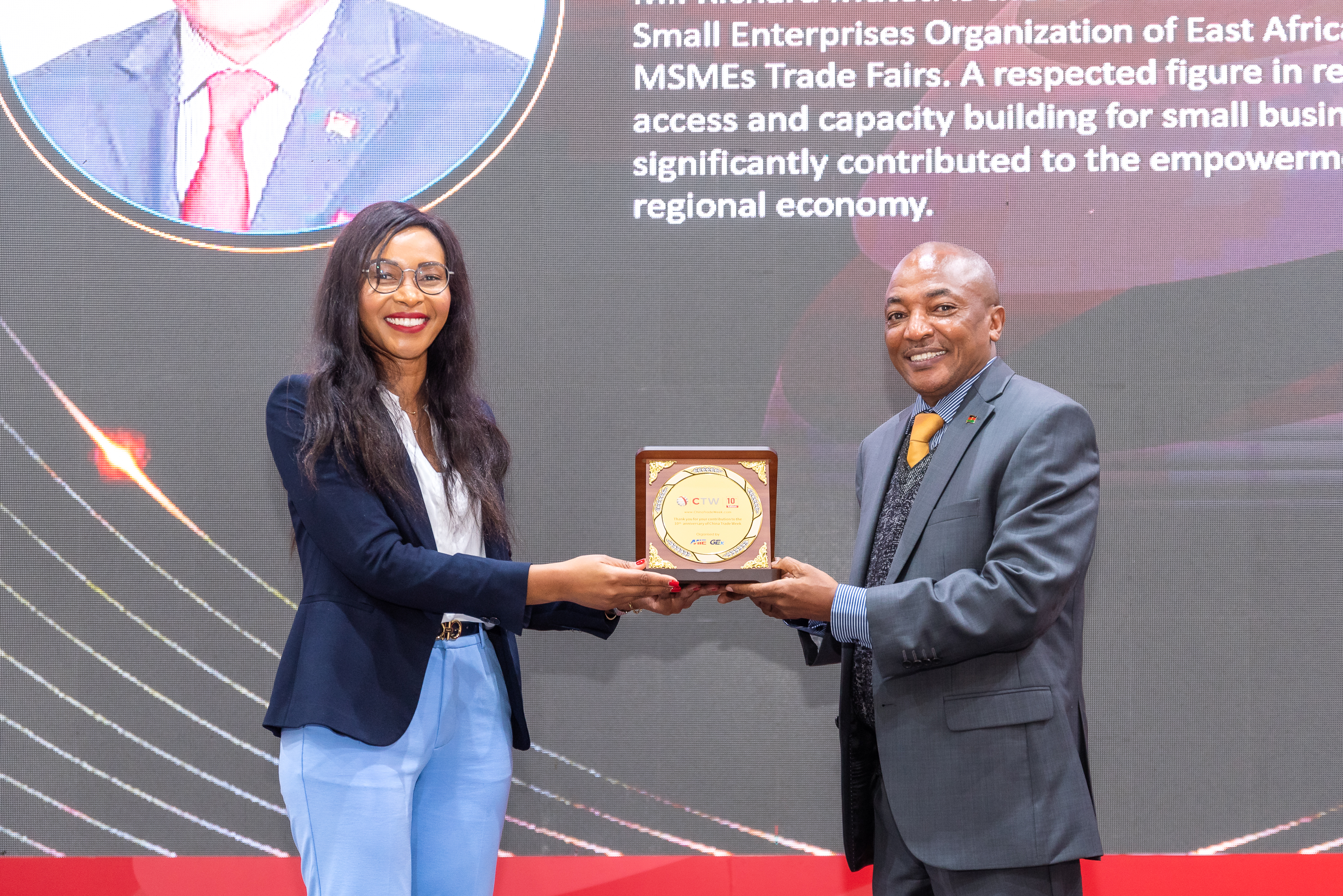 A guest receiving a plaque on stage