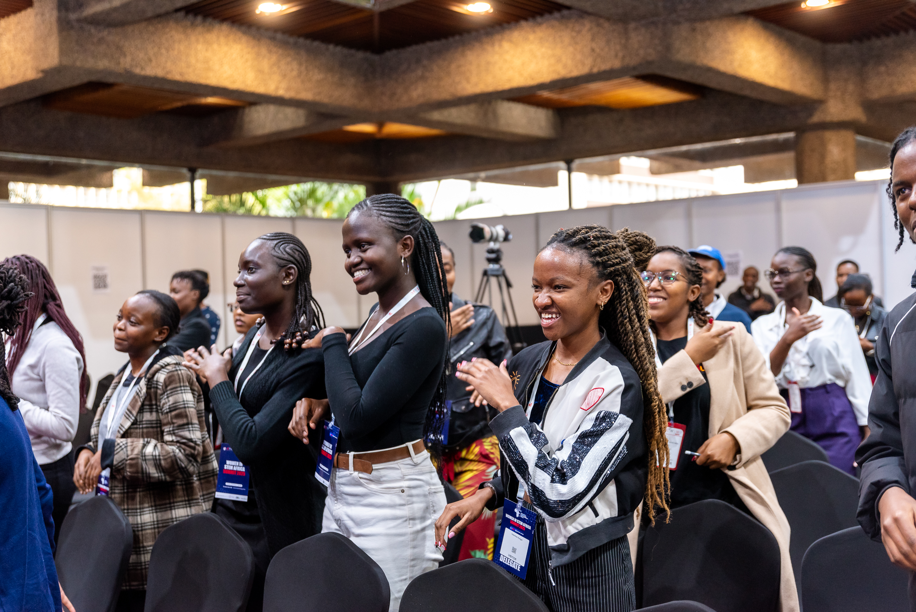 Delegates smiling and dancing between sessions on day two of the 2025 summit