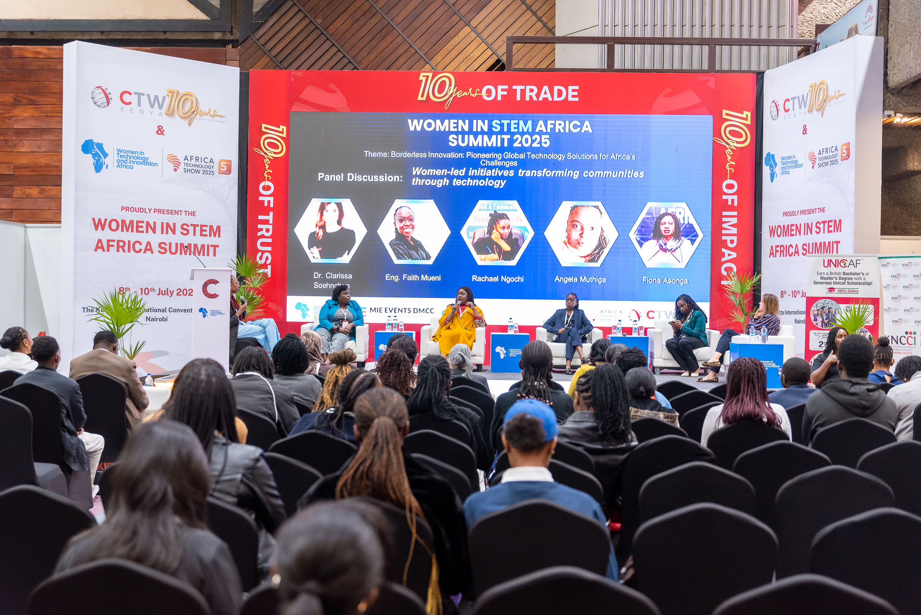 An audience watching a panel discussion on the main stage at the 2025 summit