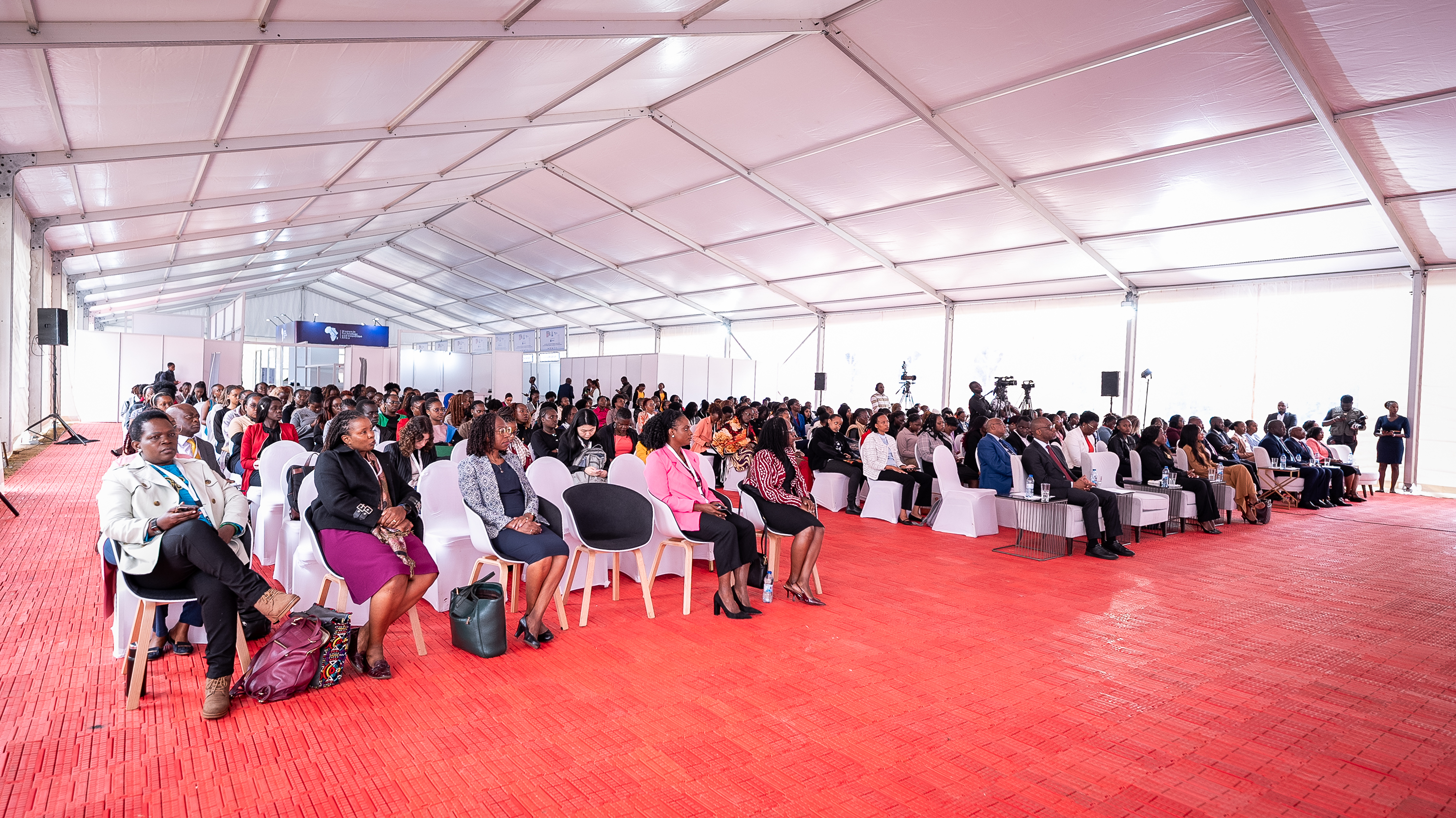 A full main hall of attendees under the summit marquee