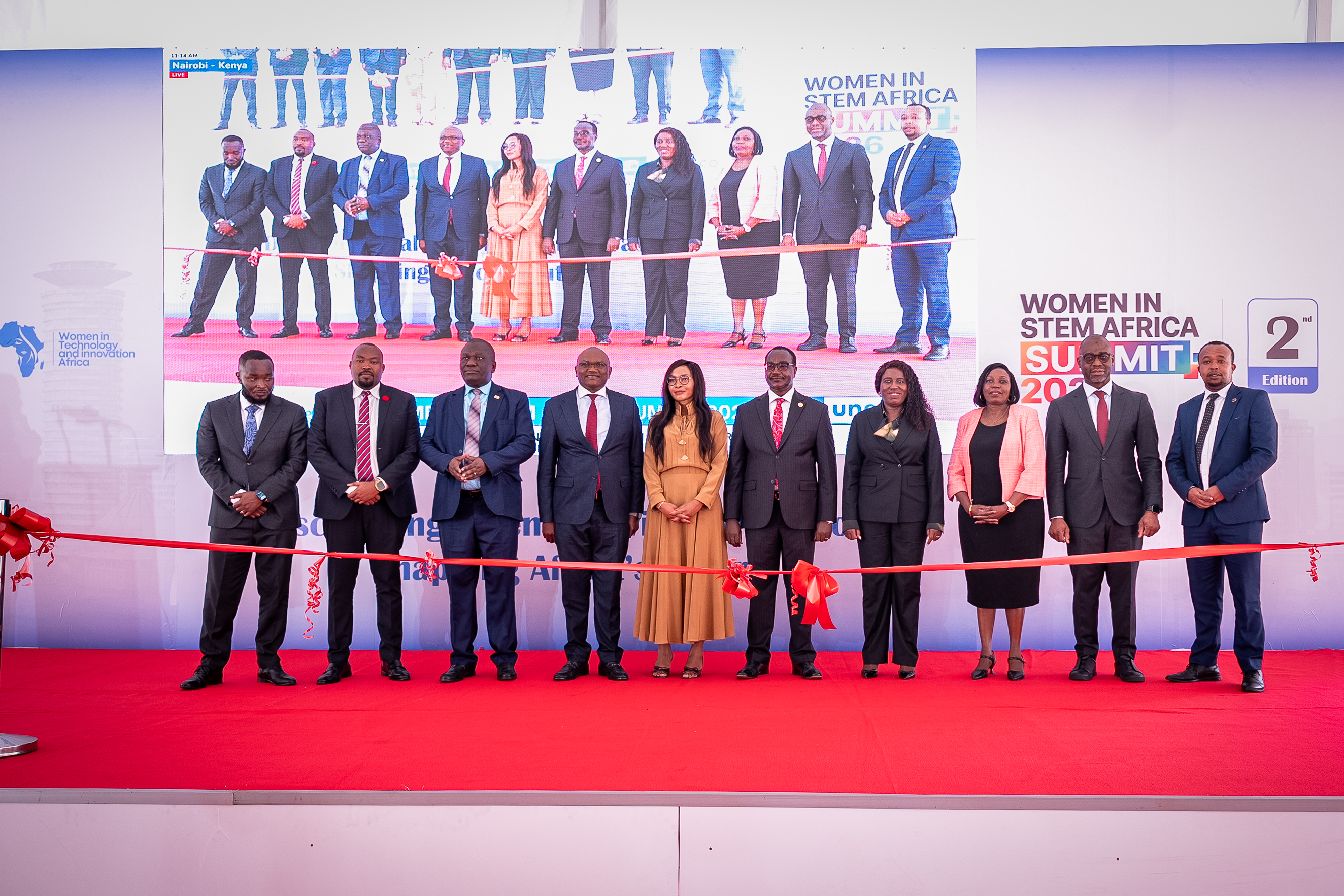 Guests lined up on stage for the opening ribbon cutting