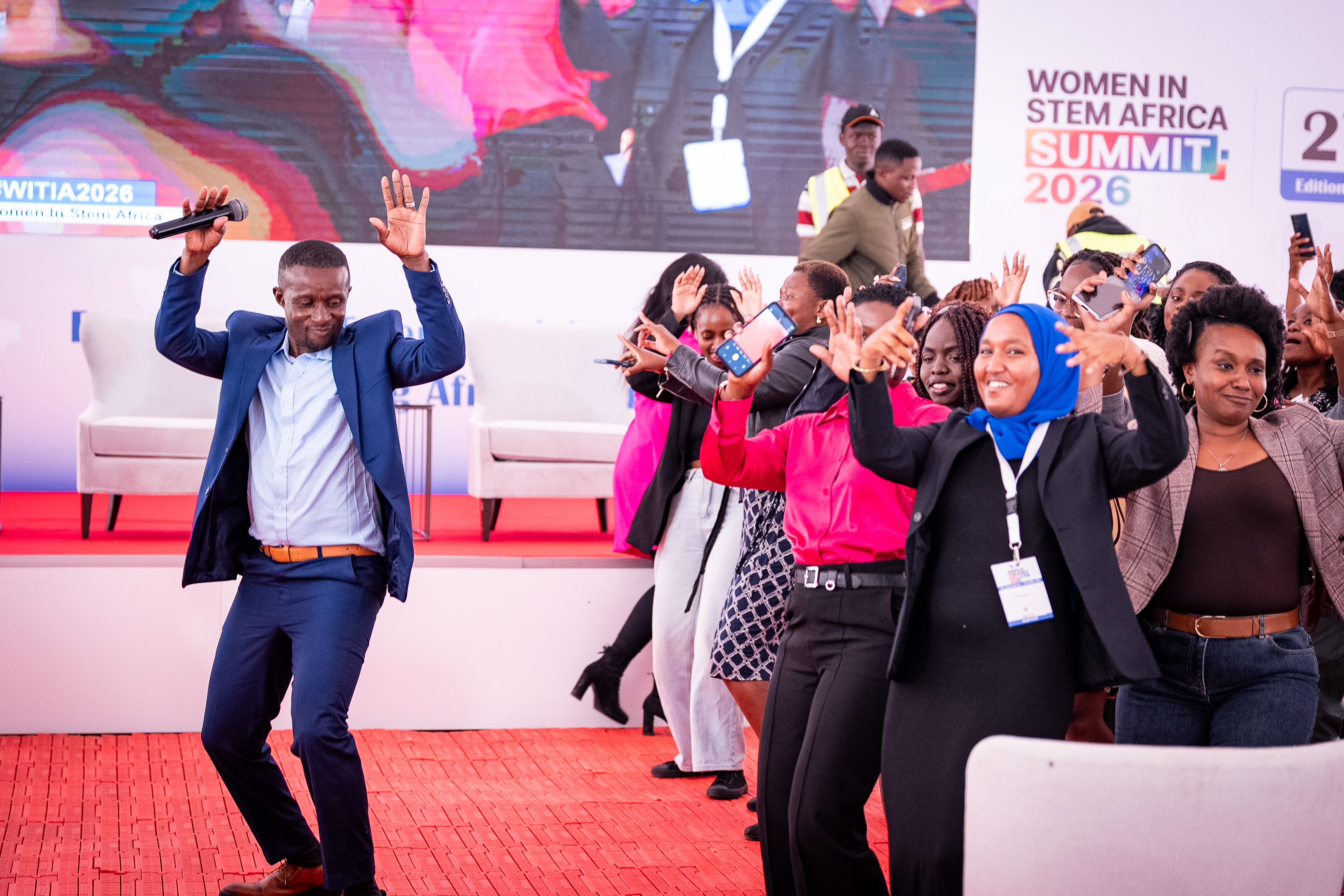 Attendees dancing in front of the stage at the 2026 summit