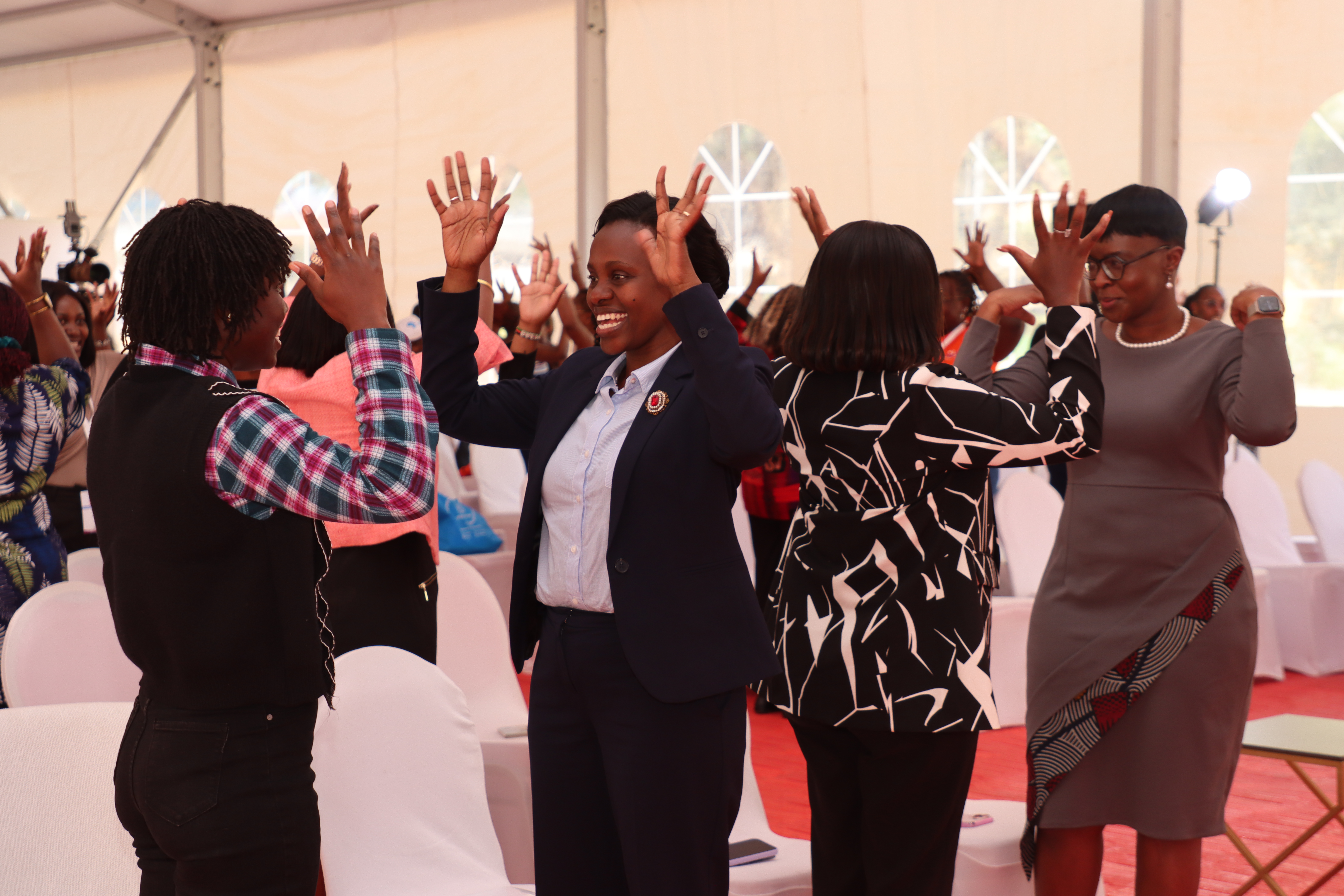Attendees on their feet dancing in the main hall